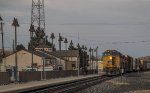 Westbound manifest freight pauses at the Alpine, Texas Amtrak station for a crw change